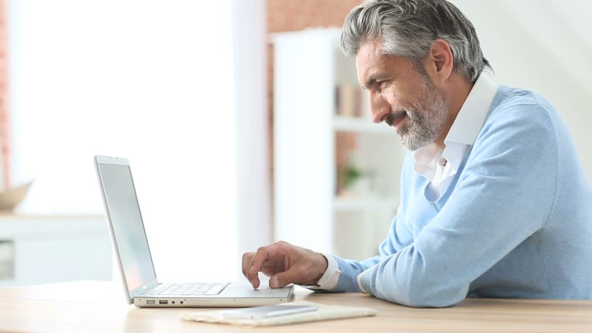 Mature Man Using Laptop at Video de stock (totalmente libre de ...